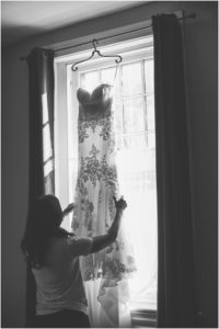 bride hangs up gown