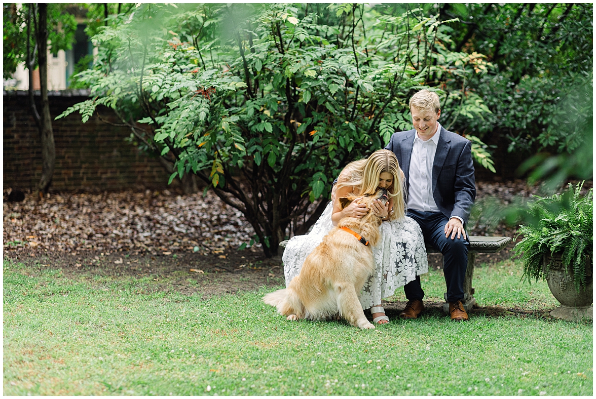 Couple Sitting on Bench During Engagement Photos, Playing with Their Dog