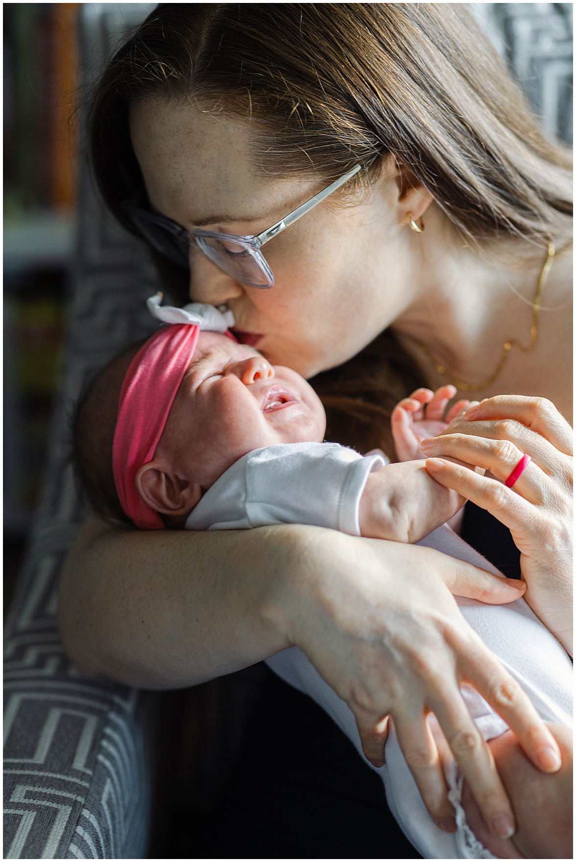 Mom Kisses Crying Newborn During Photoshoot Taking Place in Her Home