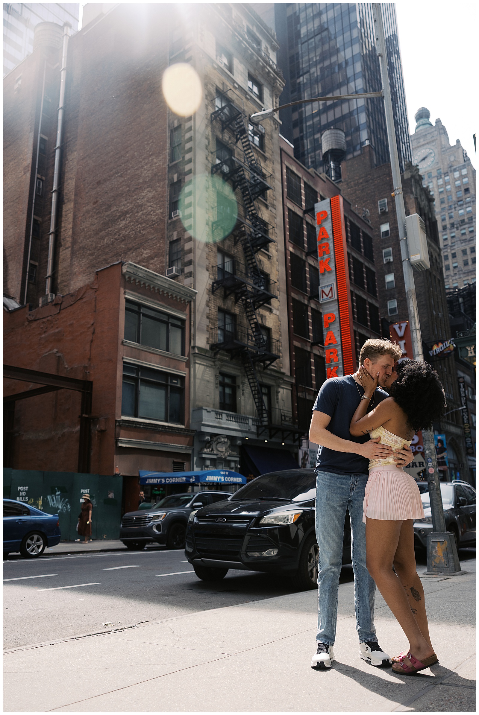 Couple Stands on Corner of Street in NYC Embracing and Kissing in Front of Historic Brick Building
