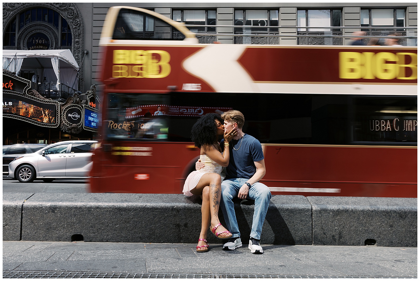 Double Decker Bus Driving By Couple While They Kiss During