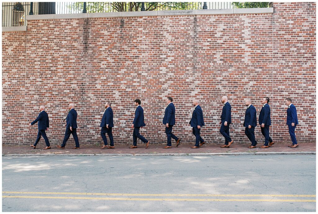 Groom and Groomsmen Walk Toward Church for Wedding Ceremony