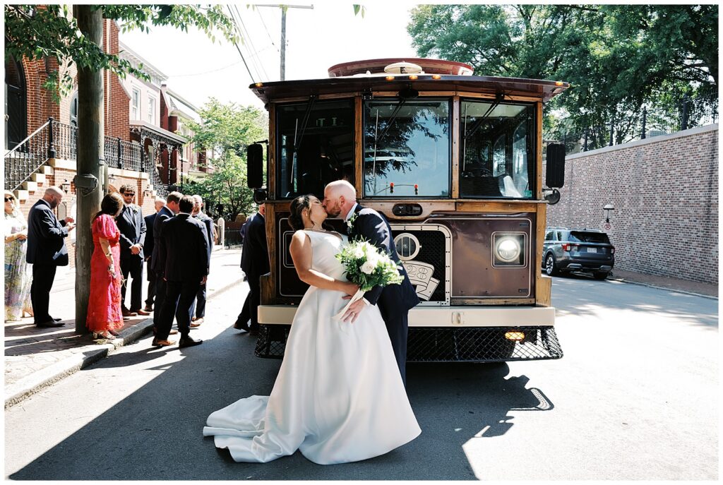 Bride and Groom Kiss in Front of Trolley